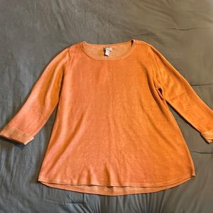 Woman’s orange shirt